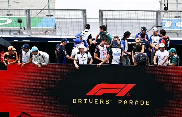 Drivers prepare for the Dirver's Parade ahead of the Formula One Bahrain Grand Prix in Sepang on October 4, 2026. (Photo by Lillian SUWANRUMPHA / AFP)