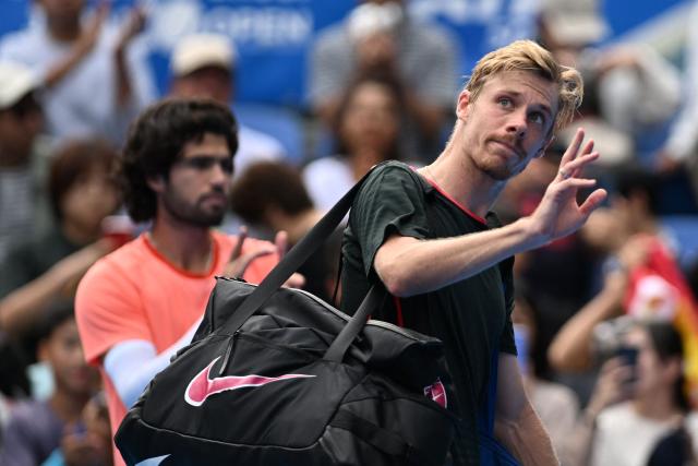 Canada's Denis Shapovalov waves to fans as he retires the men's singles quarter-final tennis match against Spain's Carlos Alcaraz due to an injury at the ATP Tour Japan Open Tennis Championships at the Ariake Tennis Forest Park in Tokyo on October 4, 2026. (Photo by Rie KIKUCHI / AFP)