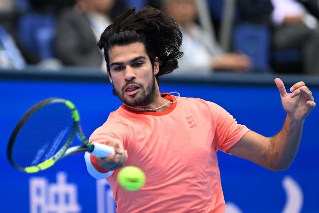 Spain's Carlos Alcaraz hits a return against Canada's Denis Shapovalov during their men's singles quarter-final tennis match at the ATP Tour Japan Open Tennis Championships at the Ariake Tennis Forest Park in Tokyo on October 4, 2026. (Photo by Rie KIKUCHI / AFP)