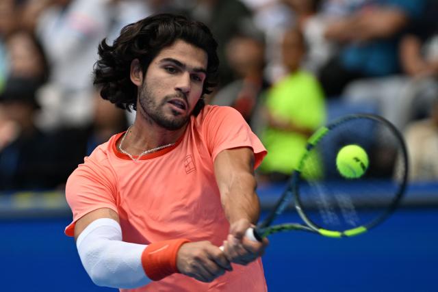 Spain's Carlos Alcaraz hits a return against Canada's Denis Shapovalov during their men's singles quarter-final tennis match at the ATP Tour Japan Open Tennis Championships at the Ariake Tennis Forest Park in Tokyo on October 4, 2026. (Photo by Rie KIKUCHI / AFP)