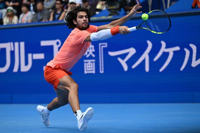 Spain's Carlos Alcaraz hits a return against Canada's Denis Shapovalov during their men's singles quarter-final tennis match at the ATP Tour Japan Open Tennis Championships at the Ariake Tennis Forest Park in Tokyo on October 4, 2026. (Photo by Rie KIKUCHI / AFP)
