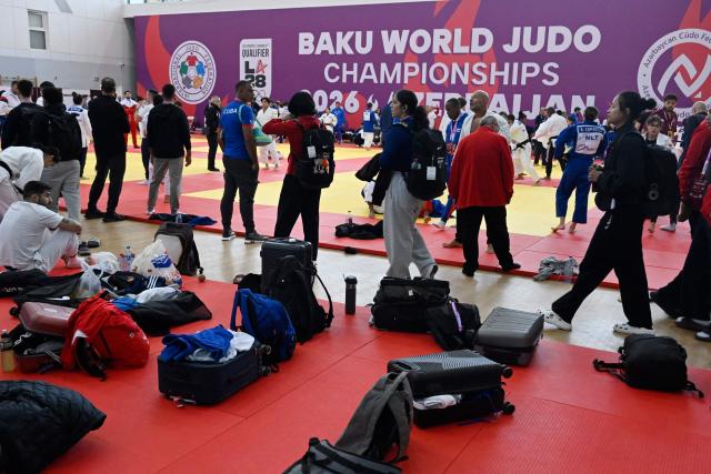 Athletes warm up prior to the first bouts at the World Judo Championships in Baku on October 4, 2026. (Photo by Alexander NEMENOV / AFP)