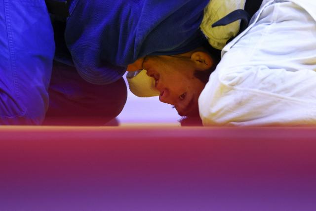 Kazakhstan's Aman Bakytzhan (blue) competes against Cuba's Jonathan Charon in the men's under 60 kg qualification round at the World Judo Championships in Baku on October 4, 2026. (Photo by Anne-Christine POUJOULAT / AFP)