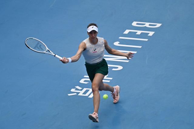 Switzerland's Viktorija Golubic hits a return to Czech Republic’s Linda Noskova during their women's singles match at the China Open tennis tournament in Beijing on October 4, 2026. (Photo by Pedro PARDO / AFP)
