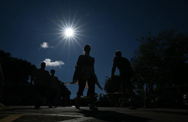 People arrive at a polling station in Sao Paulo, Brazil, on October 4, 2026, during the presidential election. Brazilians head to the polls in a highly polarized presidential election between incumbent leftist President Luiz Inacio Lula da Silva -seeking a fourth presidential mandate- and right-wing senator Flavio Bolsonaro, who emerged as the leading figure of the conservative movement following the conviction and imprisonment of his father, former president Jair Bolsonaro. (Photo by Luis ROBAYO / AFP)