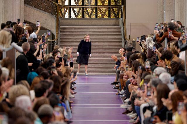 Italian designer for Miu Miu, Miuccia Prada (C) aknowledges the audience at the end of the Miu Miu Women's Spring/Summer 2027 collection fashion show as part of the Paris Fashion Week, in Paris on October 4, 2026. (Photo by GEOFFROY VAN DER HASSELT / AFP)