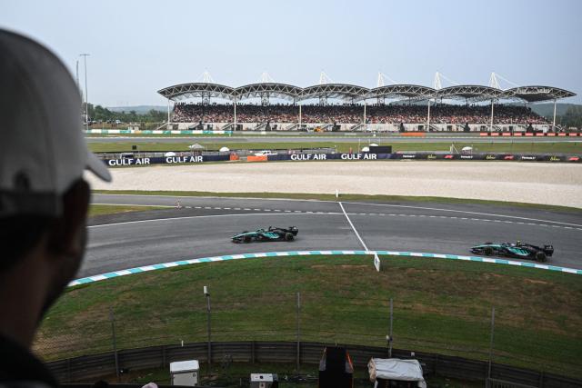 Mercedes' British driver George Russell (L) and Italian driver Kimi Antonelli steer their cars during the Formula One Bahrain Grand Prix in Sepang on October 4, 2026. (Photo by Jade GAO / AFP)