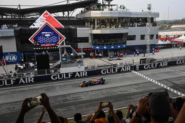 Red Bull Racing's Dutch driver Max Verstappen crosses the finishing line during the Formula One Bahrain Grand Prix in Sepang on October 4, 2026. (Photo by Jade GAO / AFP)