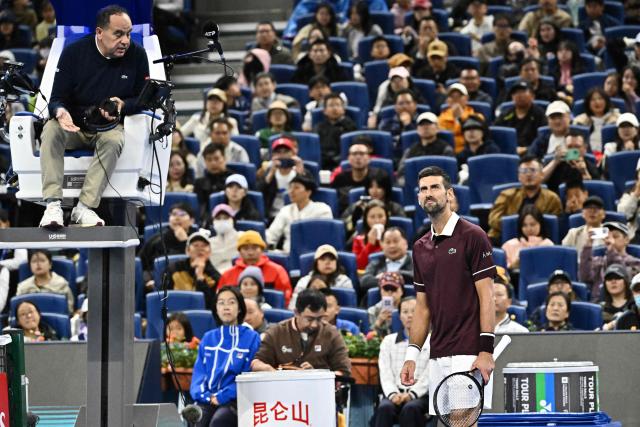 Serbia's Novak Djokovic (R) argues with the referee during his men's singles quarter-final against Germany's Alexander Zverev at the China Open tennis tournament in Beijing on October 4, 2026. (Photo by Pedro PARDO / AFP)