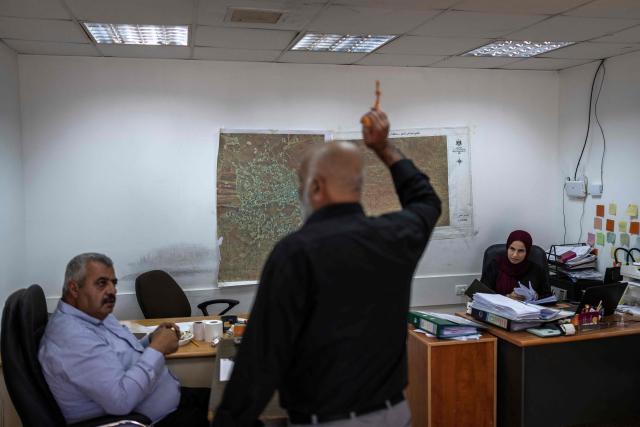 A man gestures while speaking at the mayor's office in al-Mughayyir village near Ramallah in the Israeli-occupied West Bank, on October 4, 2026. (Photo by Ilia YEFIMOVICH / AFP)