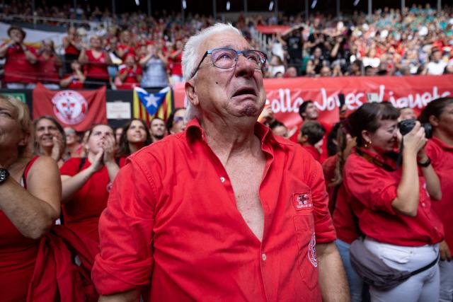 A member of the Joves de Valls team gets emotional during the 30th Castells Competition in Tarragona on October 4, 2026. The 'Castells' (castles) human towers, traditionally built during festivals in Catalonia, bring together teams attempting to construct and dismantle the tallest human tower. (Photo by Josep LAGO / AFP)