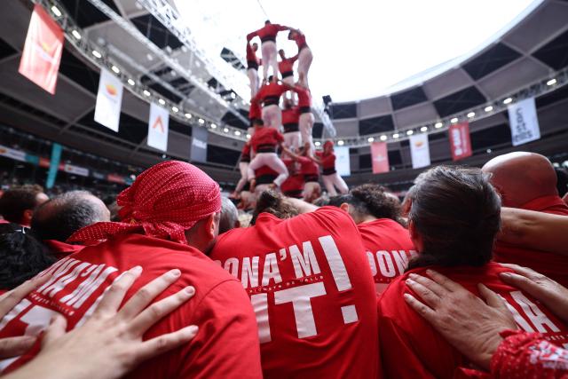 Members of the Joves de Valls team form a 'castell' (human tower) during the 30th Castells Competition in Tarragona on October 4, 2026. The 'Castells' (castles) human towers, traditionally built during festivals in Catalonia, bring together teams attempting to construct and dismantle the tallest human tower. (Photo by Josep LAGO / AFP)