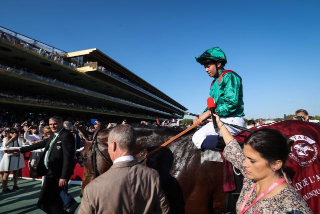 French jockey Mickael Barzalona riding Daryz (C) speaks to journalists after winning the Qatar Prix de l'Arc de Triomphe horse race at the Longchamp race course, in Paris on October 4, 2026. (Photo by MEHDI FEDOUACH / AFP)