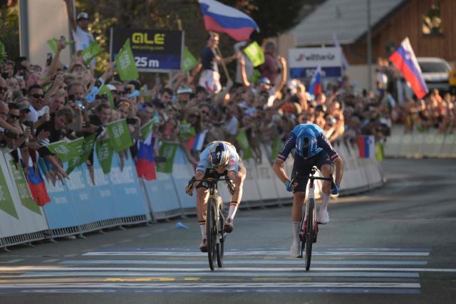 Belgium's rider Remco Evenepoel (L) crosses the finish line to win ahead of Italy's rider Giulio Ciccone the men's elite road race of the UEC European Road Cycling Championships in Sencur, near Ljubljana, Slovenia, on October 4, 2026. (Photo by JURE MAKOVEC / AFP)