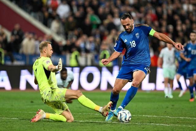 Kosovo's forward #18 Vedat Muriqi an Austria's goalkeeper #01 Alexander Schlager fight for the ball during the UEFA Nations League football match between Kosovo and Austria in Pristina on October 4, 2026. (Photo by Armend NIMANI / AFP)