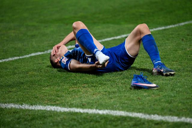 Kosovo's forward #14 Baton Zabergja grimaces on the pitch after an injury during the UEFA Nations League football match between Kosovo and Austria in Pristina on October 4, 2026. (Photo by Armend NIMANI / AFP)