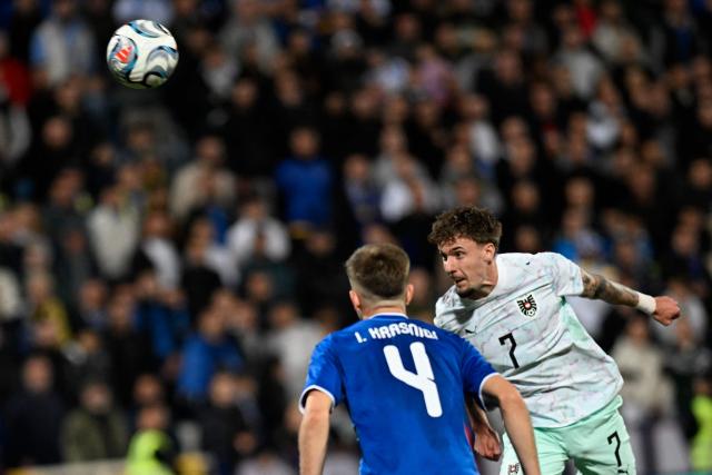 Austria's midfielder #07 Christoph Lang heads the ball during the UEFA Nations League football match between Kosovo and Austria in Pristina on October 4, 2026. (Photo by Armend NIMANI / AFP)