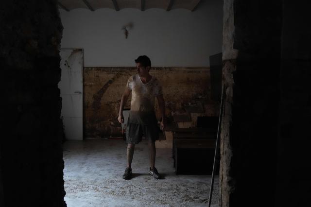 Resident Gonzalo Lozano stands in his house after floods due to torrential rains in Pineda de Mar, north of Barcelona, on October 4, 2026. Torrential rains battering eastern Spain have left two dead and kept the city of Barcelona and its surrounding areas on high alert, authorities said today, warning of the risk of flooding and overflowing rivers. (Photo by Manaure QUINTERO / AFP)