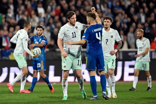 Kosovo's defender #04 Ilir Krasniqi argues with Austria's forward # Michael Gregoritsch during the UEFA Nations League football match between Kosovo and Austria in Pristina on October 4, 2026. (Photo by Armend NIMANI / AFP)