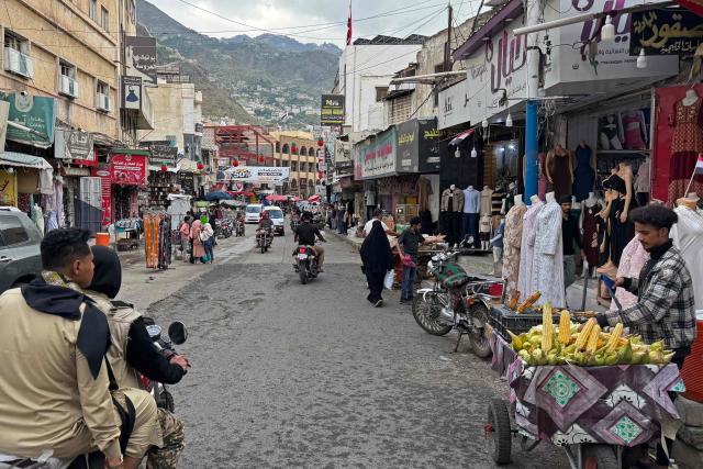 Motorists ride through a market area in Taiz on October 4, 2026. More than 70 people have been killed over the past day by fighting in and around the western Yemeni province of Taiz, sources from both sides told AFP on October 4, following days of clashes between the Iran-backed Houthi group and government forces. (Photo by AFP) / 