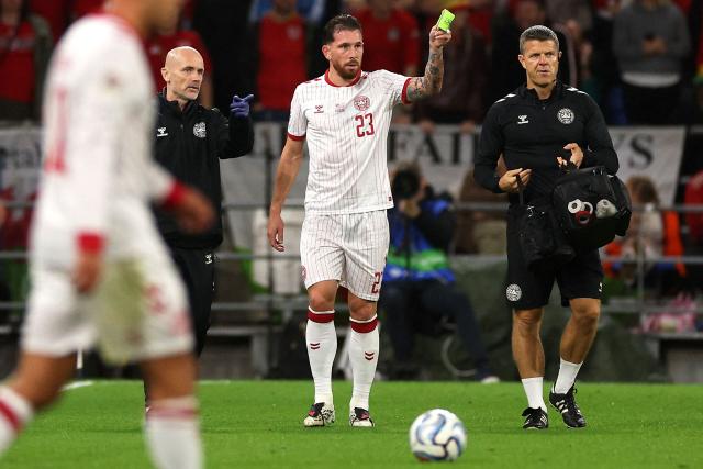 Denmark's midfielder #23 Pierre-Emile Hojbjerg hands over his captain's armband as he leaves the field of play during the UEFA Nations League, league A, group 4 football match between Wales and Denmark, at the Cardiff City Stadium in Cardiff, south Wales, on October 4, 2026. (Photo by Adrian Dennis / AFP)