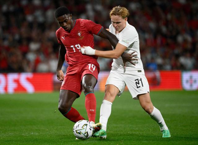 Portugal's defender #19 Nuno Mendes fights for the ball with Norway's midfielder #21 Andreas Schjelderup during the UEFA Nations League Group 4 football match between Portugal and Norway at Dragao stadium in Porto on October 3, 2026. (Photo by Miguel RIOPA / AFP)