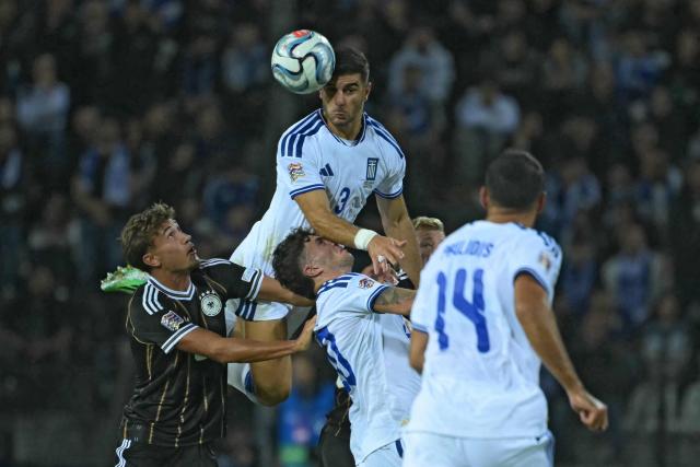 Greece's defender #03 Konstantinos Koulierakis (C) heads the ball next to Germany's defender #13 Philipp Treu (L) during the UEFA Nations League League A Group 2 matchday 4 football match between Greece and Germany at Toumba Stadium in Thessaloniki on October 4, 2026 (Photo by Aris MESSINIS / AFP)