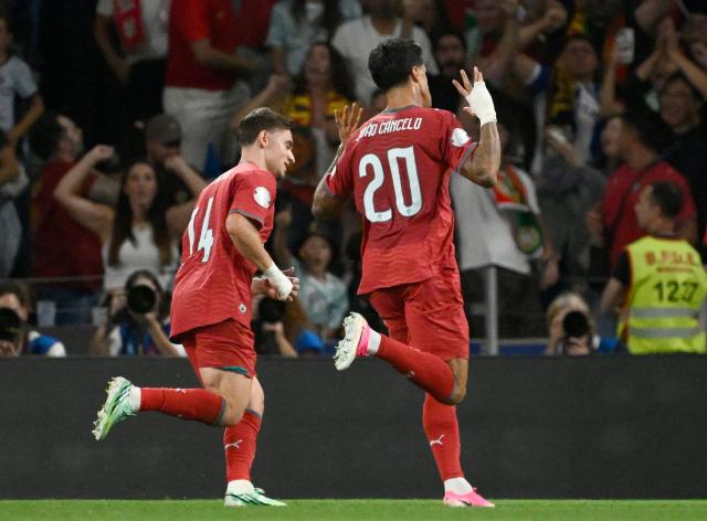 Portugal's defender #20 Joao Cancelo celebrates scoring his team's first goal during the UEFA Nations League Group 4 football match between Portugal and Norway at Dragao stadium in Porto on October 3, 2026. (Photo by Miguel RIOPA / AFP)