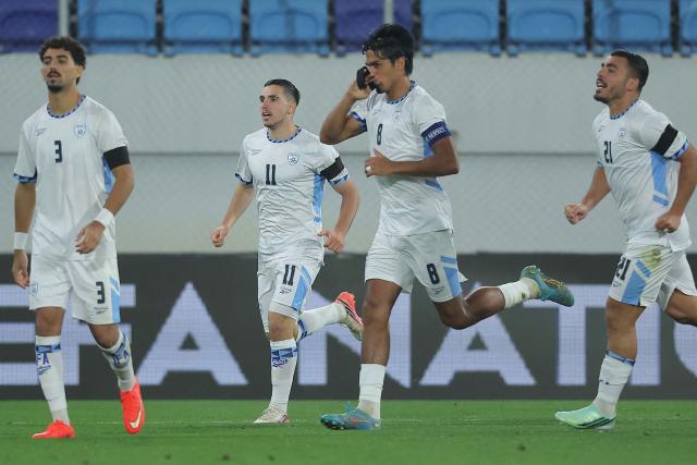 Israel's midfielder #08 Dor Peretz kisses his black armband as he celebrates scoring Israel's first goal during the UEFA Nations League Group B3 football match between the Republic of Ireland and Israel at the TSC Arena in Backa Topola on October 4, 2026. Israels players wore black armbands to commemorate the victims of Hamas' October 7, 2023 attack on Israel ahead of it's third anniversary. (Photo by Pedja Milosavljevic / AFP)