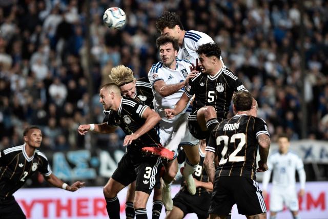 Players fight for the ball during the UEFA Nations League Group A2 football match between Greece and Germany at the Toumba Stadium in Thessaloniki on October 4, 2026. (Photo by Sakis Mitrolidis / AFP)