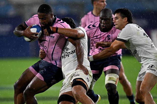 Montpellier's English centre Lennox Anyanwu is tackled during the French Top 14 rugby union match between Montpellier Herault Rugby (MHR) and Rugby Club Toulonnais (RCT) at the Stade de la Mosson in Montpellier, southern France, on October 4, 2026. (Photo by Gabriel BOUYS / AFP)