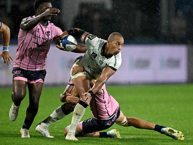 Toulon's French center Gaël Fickou is tackled during the French Top 14 rugby union match between Montpellier Herault Rugby (MHR) and Rugby Club Toulonnais (RCT) at the Stade de la Mosson in Montpellier, southern France, on October 4, 2026. (Photo by Gabriel BOUYS / AFP)