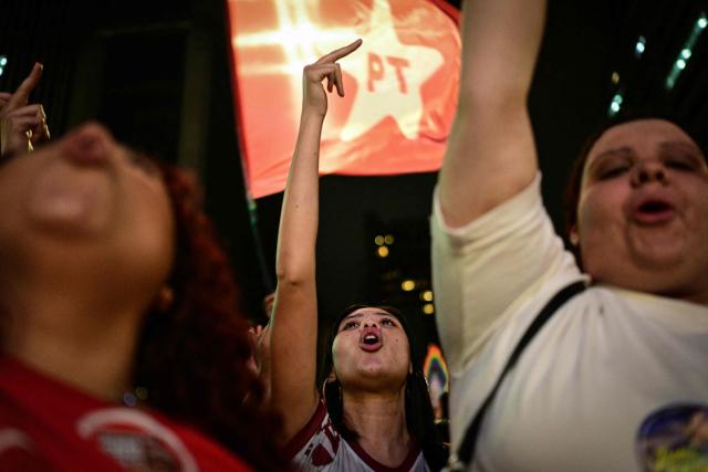 Supporters of Brazil's President and Presidential candidate Luiz Inacio Lula da Silva react after the first results of the presidential election in Sao Paulo, Brazil, on October 4, 2026. Brazilian right-wing presidential candidate Flavio Bolsonaro maintained a strong lead over President Luiz Inacio Lula da Silva with presidential election results from over 60 percent of electronic ballot boxes counted. (Photo by Pablo PORCIUNCULA / AFP)