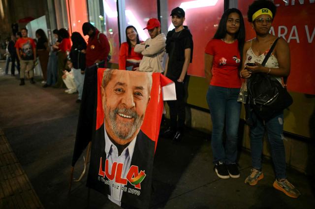 Supporters of Brazil's President and Presidential candidate Luiz Inacio Lula da Silva follow the partial results of the presidential election in Sao Paulo, Brazil on October 4, 2026. Brazilian senator Flavio Bolsonaro, son of the far-right former president Jair Bolsonaro, is leading incumbent Luiz Inacio Lula da Silva in partial results from October 4, 2026, election. (Photo by Luis ROBAYO / AFP)