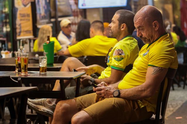 Supporters of Brazil's President and Presidential candidate Luiz Inacio Lula da Silva wait for the final results of the presidential election in Rio de Janeiro, Brazil, on October 4, 2026. Brazilian senator Flavio Bolsonaro, son of the far-right former president Jair Bolsonaro, is leading incumbent Luiz Inacio Lula da Silva in partial results from October 4, 2026, election. (Photo by Douglas SHINEIDR / AFP)
