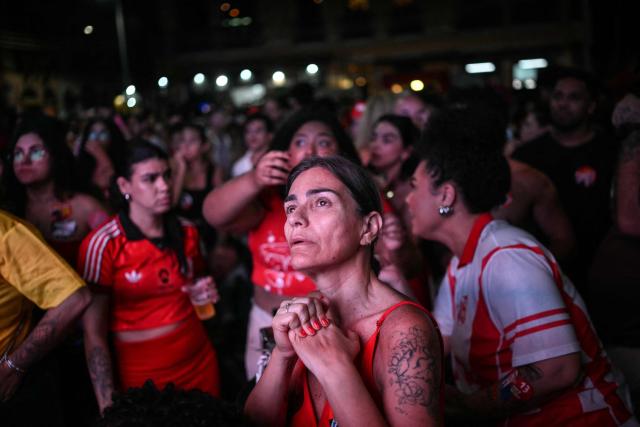 A supporter of Brazil's President and presidential candidate Luiz Inacio Lula da Silva reacts following the first results of the presidential election in Rio Janeiro, Brazil, on October 4, 2026. Brazilian senator Flavio Bolsonaro, son of the far-right former president Jair Bolsonaro, is leading incumbent Luiz Inacio Lula da Silva in partial results from October 4, 2026, election. (Photo by MAURO PIMENTEL / AFP)
