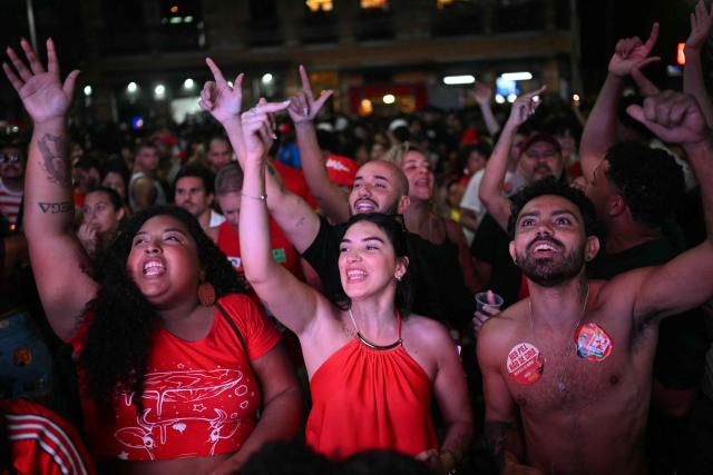 Supporters of Brazil's President and Presidential candidate Luiz Inacio Lula da Silva react following the partial results of the presidential election in Rio de Janeiro, Brazil on October 4, 2026. Brazilian senator Flavio Bolsonaro, son of the far-right former president Jair Bolsonaro, is leading incumbent Luiz Inacio Lula da Silva in partial results from October 4, 2026, election. (Photo by MAURO PIMENTEL / AFP)