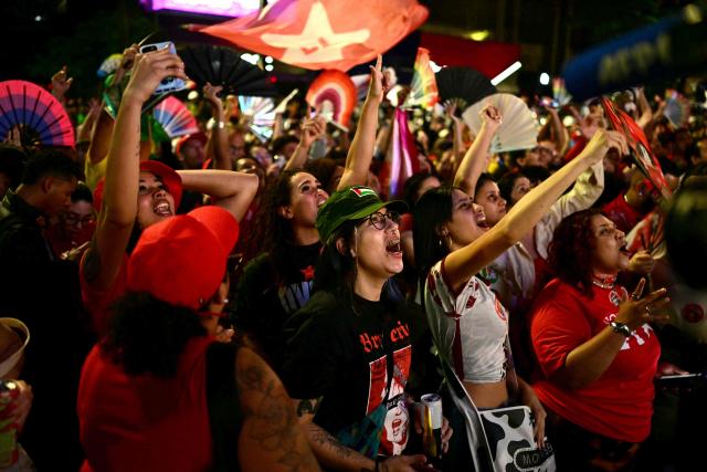 Supporters of Brazil's President and Presidential candidate Luiz Inacio Lula da Silva react following the partial results of the presidential election in Sao Paulo, Brazil on October 4, 2026. Brazilian senator Flavio Bolsonaro, son of the far-right former president Jair Bolsonaro, is leading incumbent Luiz Inacio Lula da Silva in partial results from October 4, 2026, election. (Photo by Pablo PORCIUNCULA / AFP)