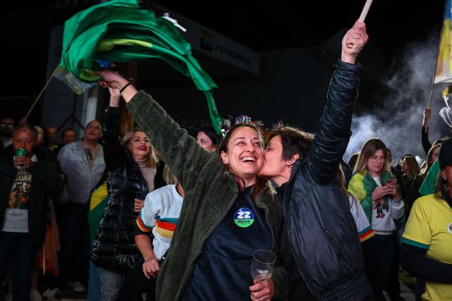 Supporters of Brazil's right-wing presidential candidate Flavio Bolsonaro celebrate the results of the presidential election in Porto Alegre, Brazil, on October 4, 2026. Brazilian senator Flavio Bolsonaro, son of the far-right former president Jair Bolsonaro, is leading incumbent Luiz Inacio Lula da Silva in partial results from October 4, 2026, election. (Photo by SILVIO AVILA / AFP)