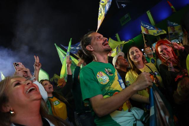 Supporters of Brazil's right-wing presidential candidate Flavio Bolsonaro celebrate the results of the presidential election in Porto Alegre, Brazil, on October 4, 2026. Brazilian senator Flavio Bolsonaro, son of the far-right former president Jair Bolsonaro, is leading incumbent Luiz Inacio Lula da Silva in partial results from October 4, 2026, election. (Photo by SILVIO AVILA / AFP)