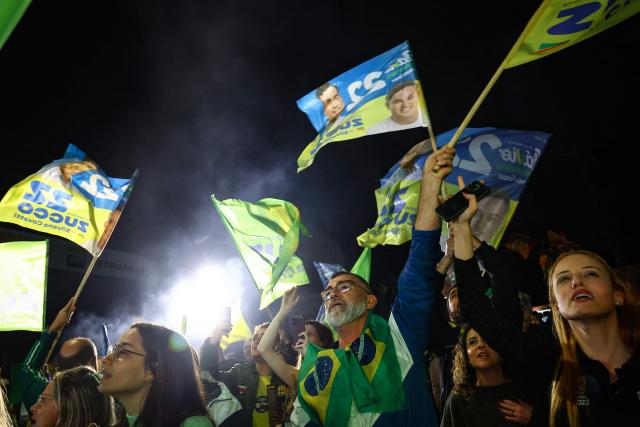 Supporters of Brazil's right-wing presidential candidate Flavio Bolsonaro celebrate the results of the presidential election in Porto Alegre, Brazil, on October 4, 2026. Brazilian senator Flavio Bolsonaro, son of the far-right former president Jair Bolsonaro, is leading incumbent Luiz Inacio Lula da Silva in partial results from October 4, 2026, election. (Photo by SILVIO AVILA / AFP)