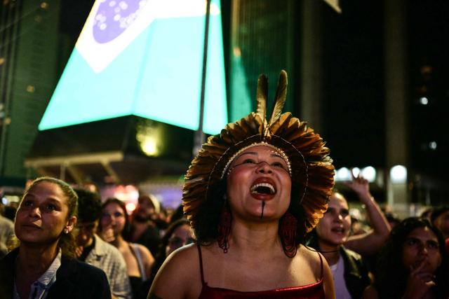 A supporter of Brazil's President and Presidential candidate Luiz Inacio Lula da Silva reacts following the results of the presidential election in Sao Paulo, Brazil on October 4, 2026. Brazilian senator Flavio Bolsonaro, son of the far-right former president Jair Bolsonaro, is leading incumbent Luiz Inacio Lula da Silva in partial results from October 4, 2026, election. (Photo by Pablo PORCIUNCULA / AFP)