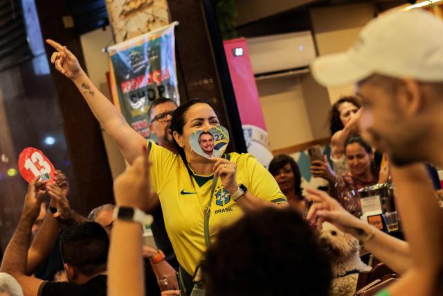 A supporter of Brazil's right-wing Presidential candidate Flavio Bolsonaro reacts following the partial results of the presidential election in Rio de Janeiro, Brazil, on October 4, 2026. Brazilian senator Flavio Bolsonaro, son of the far-right former president Jair Bolsonaro, is leading incumbent Luiz Inacio Lula da Silva in partial results from October 4, 2026, election. (Photo by Douglas SHINEIDR / AFP)