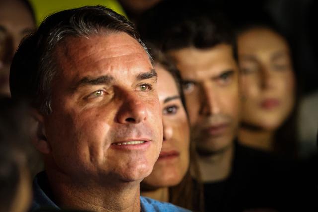 Brazil's right-wing senator and presidential candidate for the Liberal Party (PL) Flavio Bolsonaro speaks to supporters following the partial results of the presidential election in Brasilia, Brazil on October 4, 2026. Brazilian senator Flavio Bolsonaro, son of the far-right former leader Jair Bolsonaro, finished ahead of President Luiz Inacio Lula da Silva in the election on October 4, 2026, which will go to a run-off in three weeks. (Photo by Sergio LIMA / AFP)