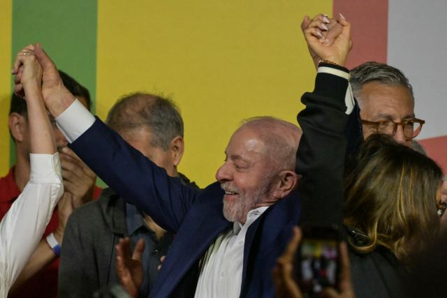 Brazil's President and re-election candidate for the Workers' Party (PT) Luiz Inacio Lula da Silva raises his arms following the partial results of the presidential election in Sao Paulo, Brazil on October 4, 2026. Brazilian senator Flavio Bolsonaro, son of the far-right former leader Jair Bolsonaro, finished ahead of President Luiz Inacio Lula da Silva in the election on October 4, 2026, which will go to a run-off in three weeks. (Photo by NELSON ALMEIDA / AFP)