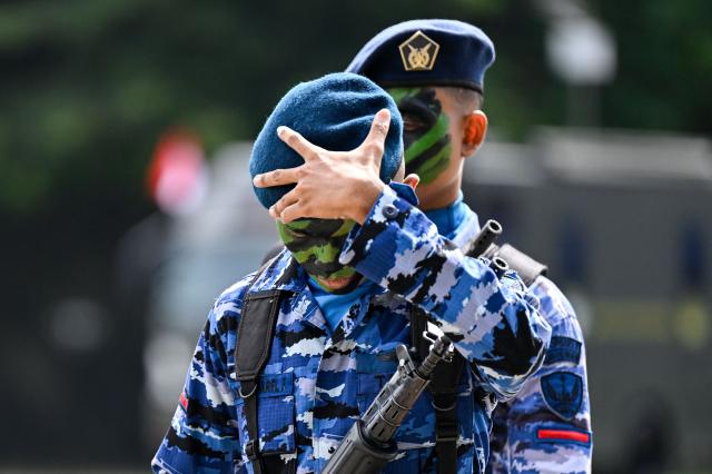 Indonesian air force personnel gesture after taking part in the 81th anniversary of the Indonesian National Armed Forces (TNI) in Banda Aceh on October 5, 2026. (Photo by CHAIDEER MAHYUDDIN / AFP)