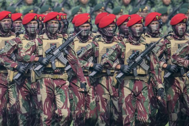 Kopassus soldiers march in formation during the 81st Indonesian National Armed Forces Day Parade in Cilangkap, East Jakarta, on October 5, 2026. (Photo by BAY ISMOYO / AFP)
