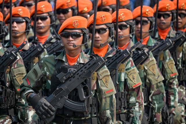 Air Force Quick Reaction Force Command (KOPASGAT) soldiers from the Indonesian Air Force, wearing their distinctive orange berets, march in formation during the 81st TNI Anniversary Day Parade in Cilangkap, East Jakarta, on October 5, 2026. (Photo by BAY ISMOYO / AFP)