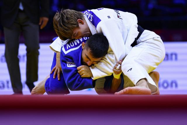 Finland's Luukas Saha (white competes against Azerbaijan's Turan Bayramov in the men's under 66 kg round of 64 at the World Judo Championships in Baku on October 5, 2026. (Photo by Anne-Christine POUJOULAT / AFP)