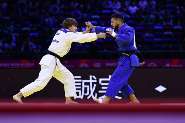 Finland's Luukas Saha (white competes against Azerbaijan's Turan Bayramov in the men's under 66 kg round of 64 at the World Judo Championships in Baku on October 5, 2026. (Photo by Anne-Christine POUJOULAT / AFP)
